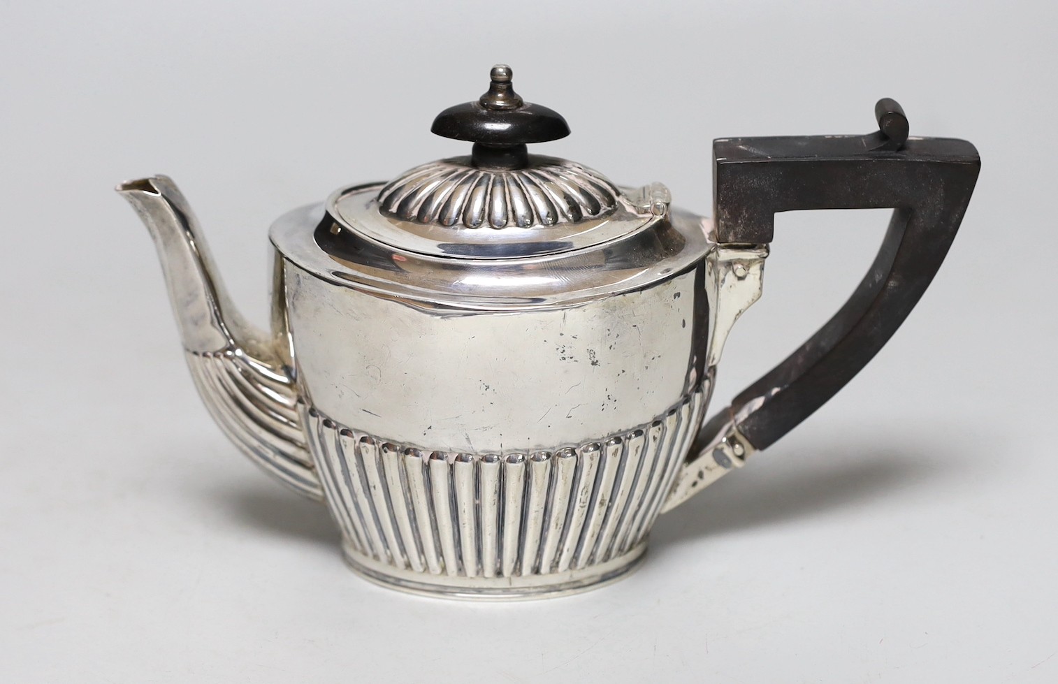 A late Victorian demi-fluted silver bachelor's teapot, London, 1885, gross weight 8.3oz.